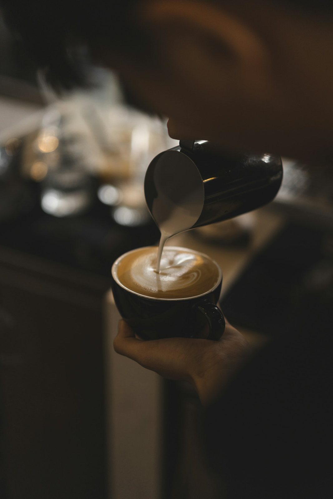 Milk being poured into a latte
